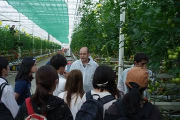 Group of students visiting professional tomato production sites and laboratories